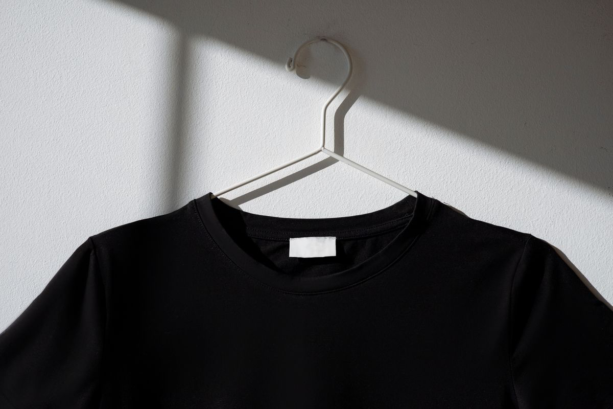 Blank black T-shirt mockup with a dramatic studio shadow